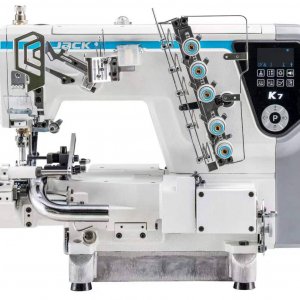 Industrial sewing machine with exposed mechanisms and a digital control panel on the right, labeled K7, mounted on a sturdy base.